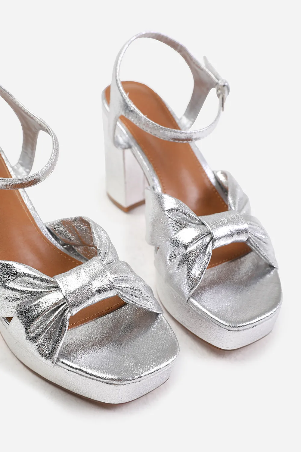 TALIA MID BLOCK HEEL WITH PLAFTORM AND BOW DETAILING IN SILVER FAUX LEATHER